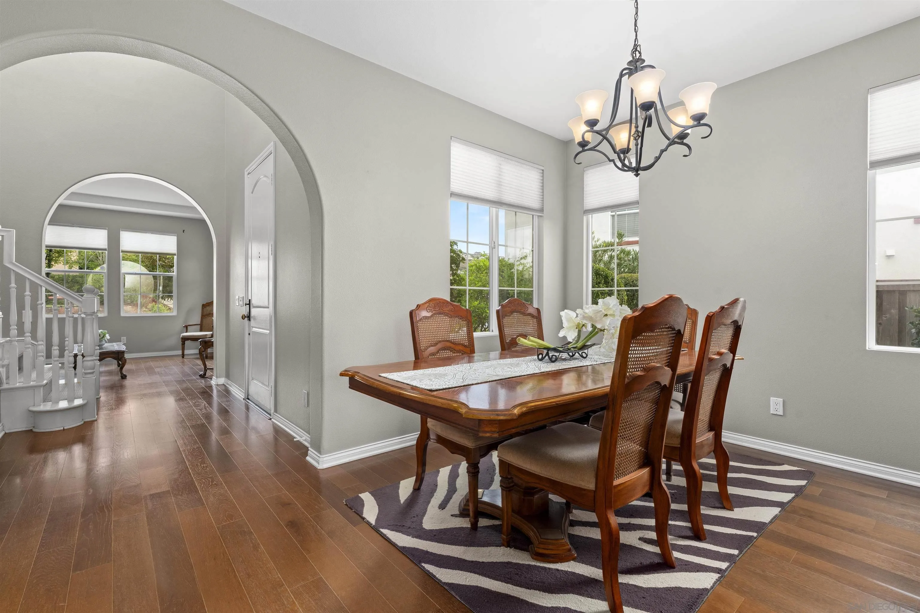 840 Luminara Way San Marcos, CA 92078 - Photo 9 of 57 a view of a dining room with furniture a chandelier and wooden floor