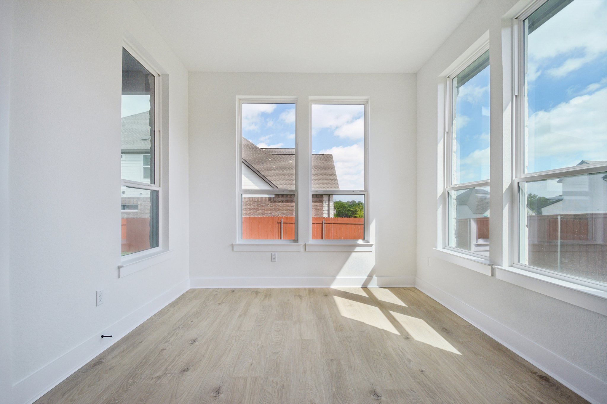 1660 Cardinal Lane Round Rock, TX 78681 - Photo 20 of 35 an empty room with wooden floor and windows