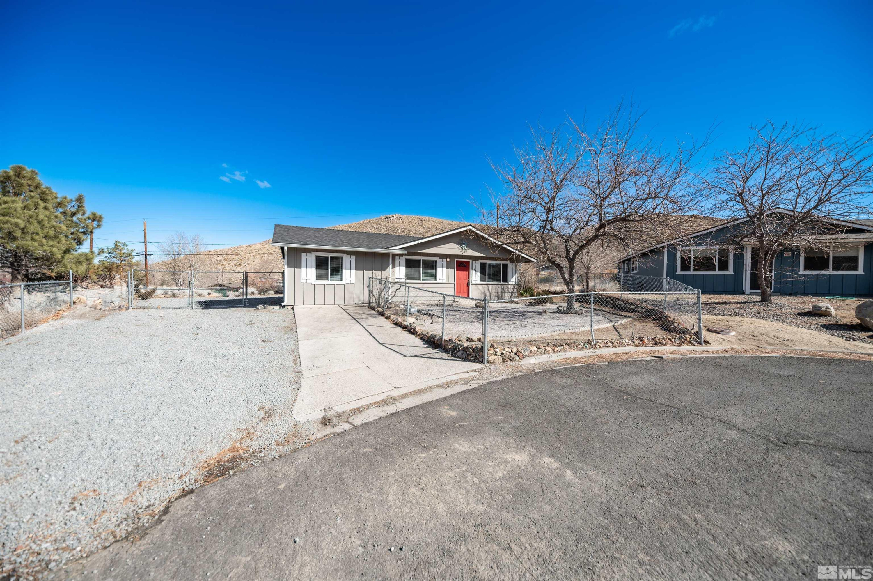 495 Kess Court Reno, NV 89506 - Photo 17 of 18 a front view of a building with large trees