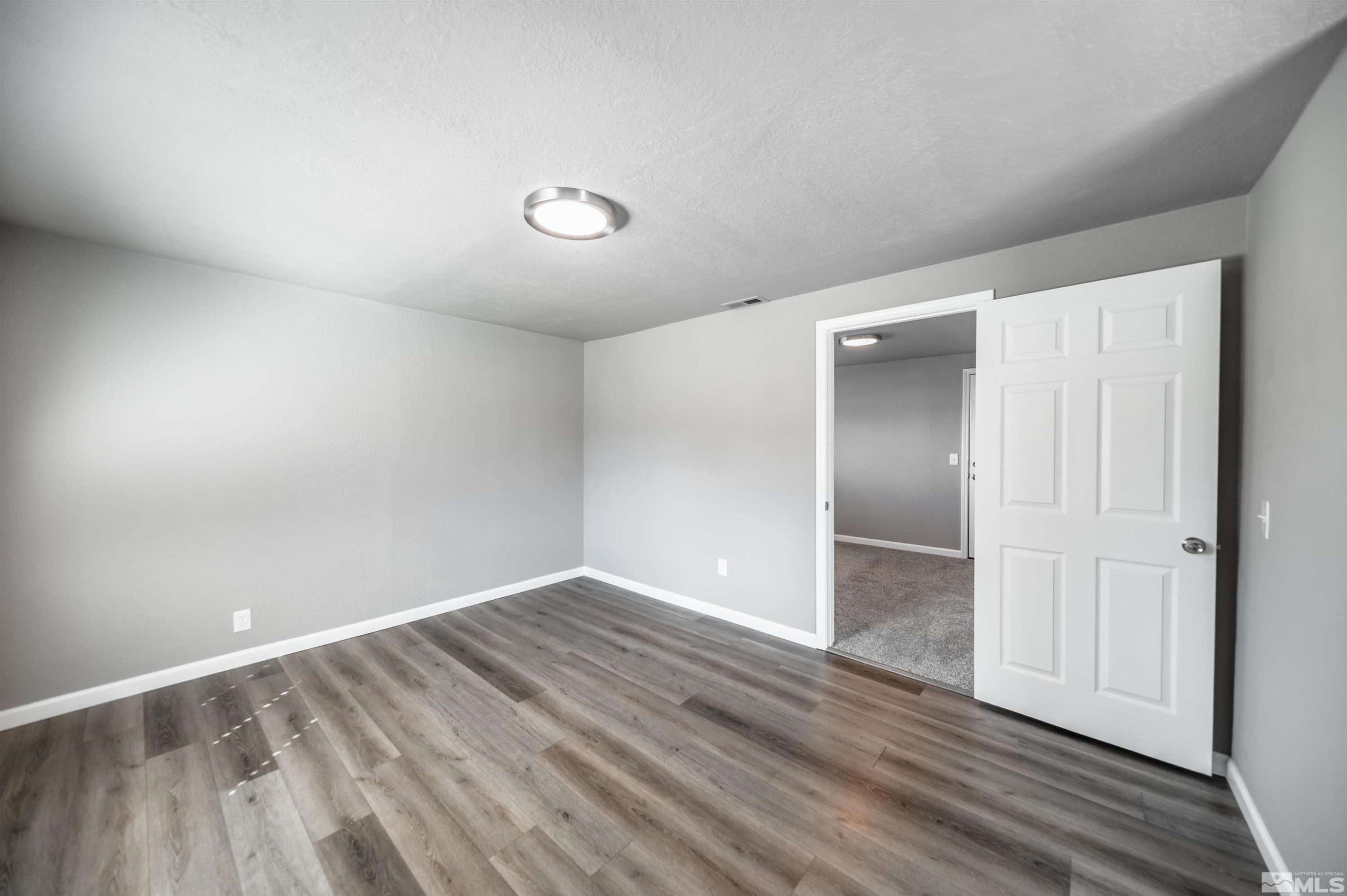 495 Kess Court Reno, NV 89506 - Photo 7 of 18 wooden floor in an empty room
