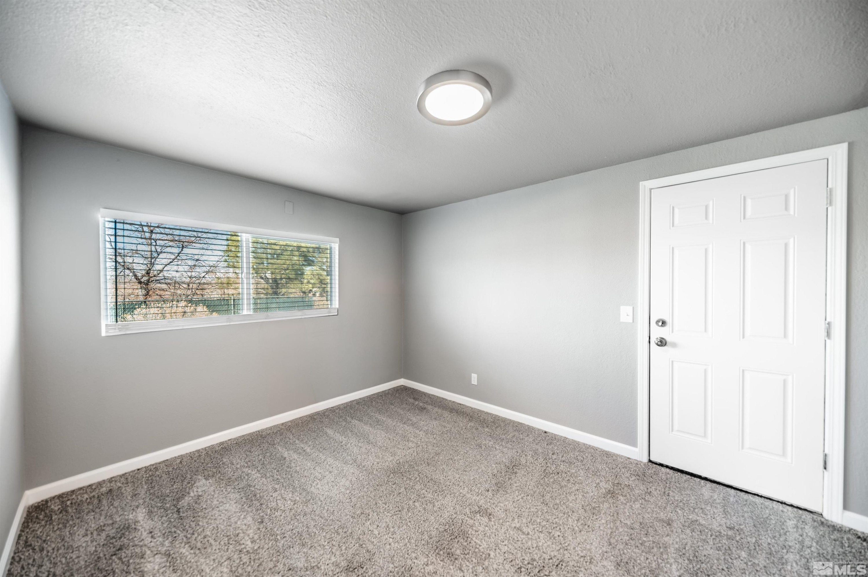495 Kess Court Reno, NV 89506 - Photo 8 of 18 an empty room with a window