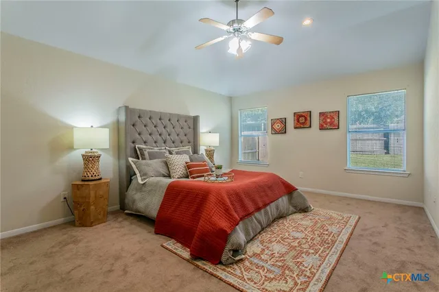 a bed room with a bed and a chandelier