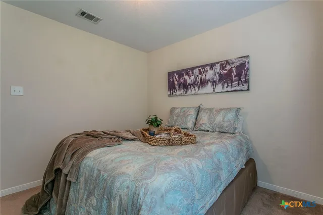 a bed sitting in a bedroom next to a wall