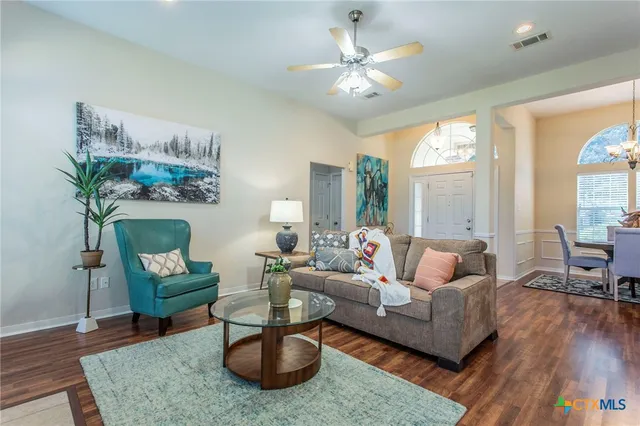 a living room with furniture rug and window