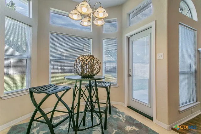 a view of a dining room with furniture wooden floor and chandelier