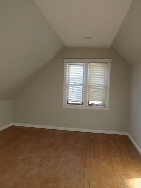 98 Brookline Street, Unit 3 Worcester, MA 01603 - Photo 15 of 33 an empty room with wooden floor and windows
