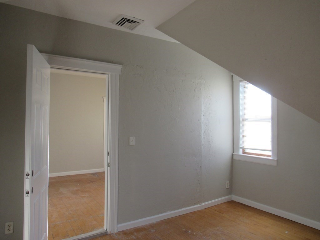 98 Brookline Street, Unit 3 Worcester, MA 01603 - Photo 16 of 33 an empty room with windows and closet