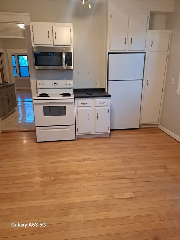 98 Brookline Street, Unit 3 Worcester, MA 01603 - Photo 30 of 33 a kitchen with stainless steel appliances a refrigerator sink and cabinets