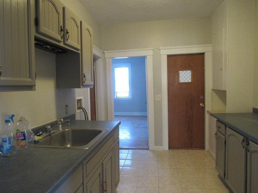 98 Brookline Street, Unit 3 Worcester, MA 01603 - Photo 32 of 33 a kitchen with a sink stove and cabinets