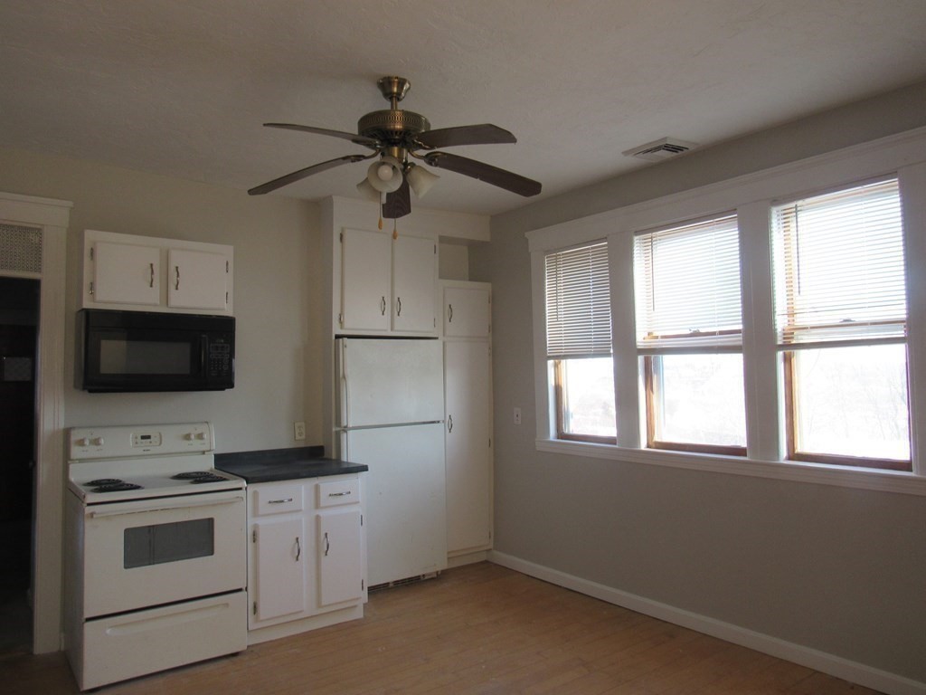 98 Brookline Street, Unit 3 Worcester, MA 01603 - Photo 7 of 33 a kitchen with a stove and a microwave