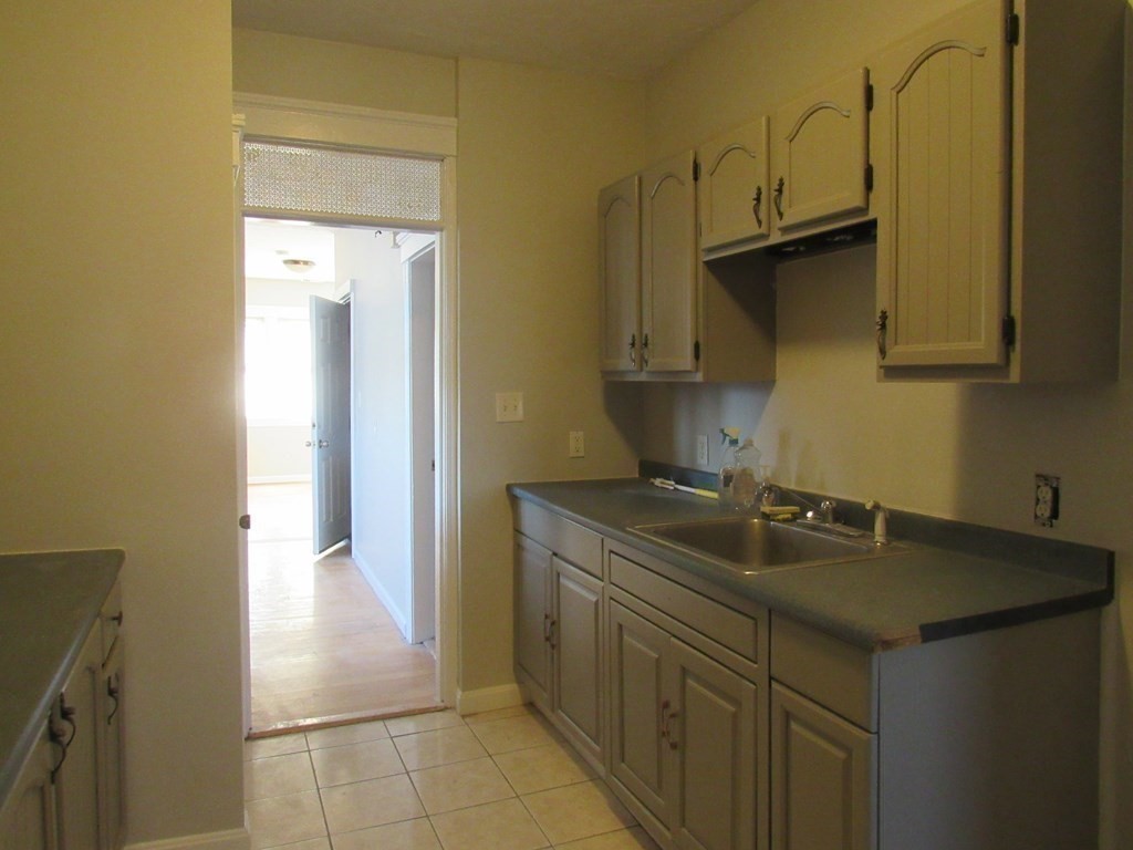 98 Brookline Street, Unit 3 Worcester, MA 01603 - Photo 8 of 33 a kitchen with a sink and cabinets