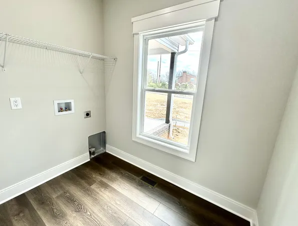 a view of a room with wooden floor and windows