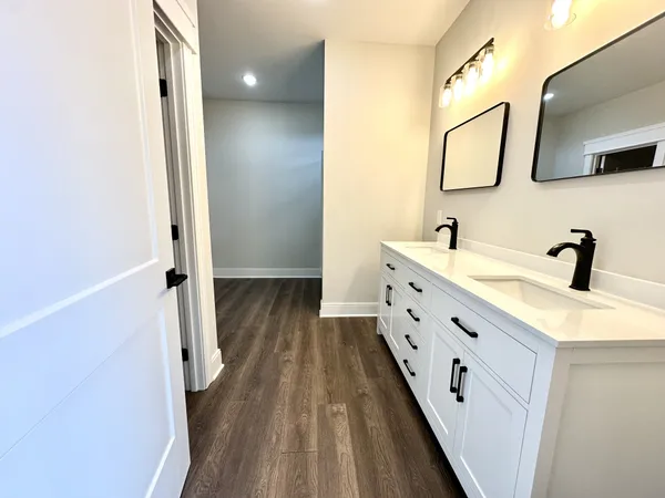 a bathroom with a double vanity sink and mirror