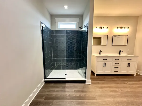 a bathroom with a sink a mirror and shower