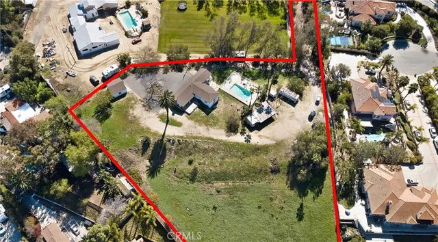 a backyard of a residential building with trees in front of it