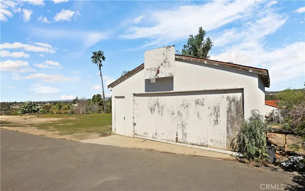 a front view of a house with swimming pool having outdoor seating