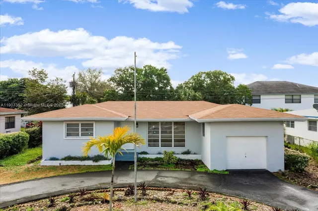 a view of a white house with a swimming pool and outdoor seating