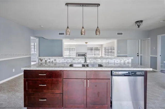 a kitchen with a sink and cabinets