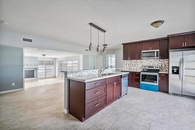 a large kitchen with a stove and cabinets