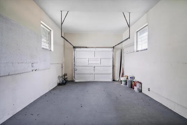 an empty room with closet and windows