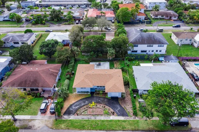 an aerial view of multiple houses with yard