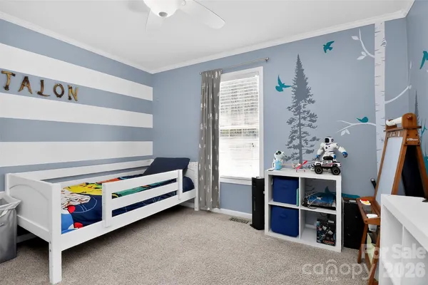 a bedroom with furniture and a flat screen tv