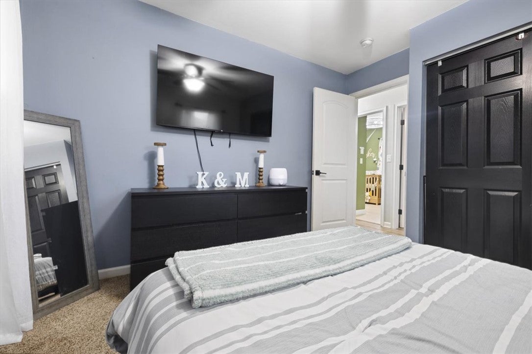 1482 Lee Road Troy, OH 45373 - Photo 16 of 30 This cozy bedroom features a stylish ceiling fan and soft carpeting, creating a tranquil retreat.