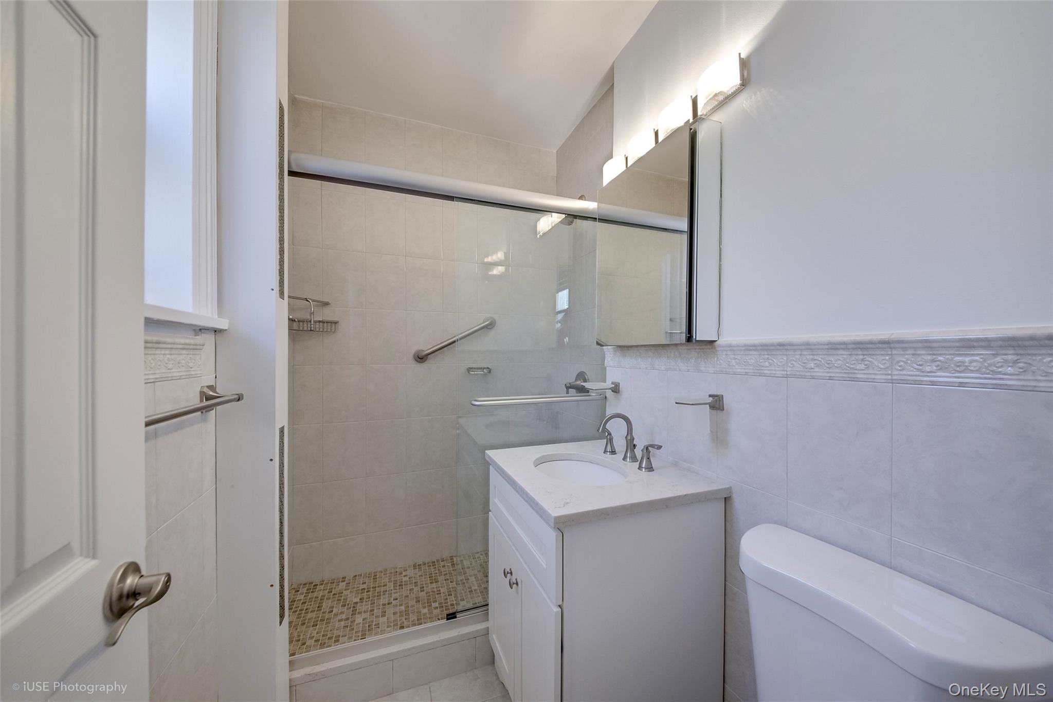 48-41 43rd Street, Unit 5F Queens, NY 11377 - Photo 7 of 8 a bathroom with a toilet a sink and shower