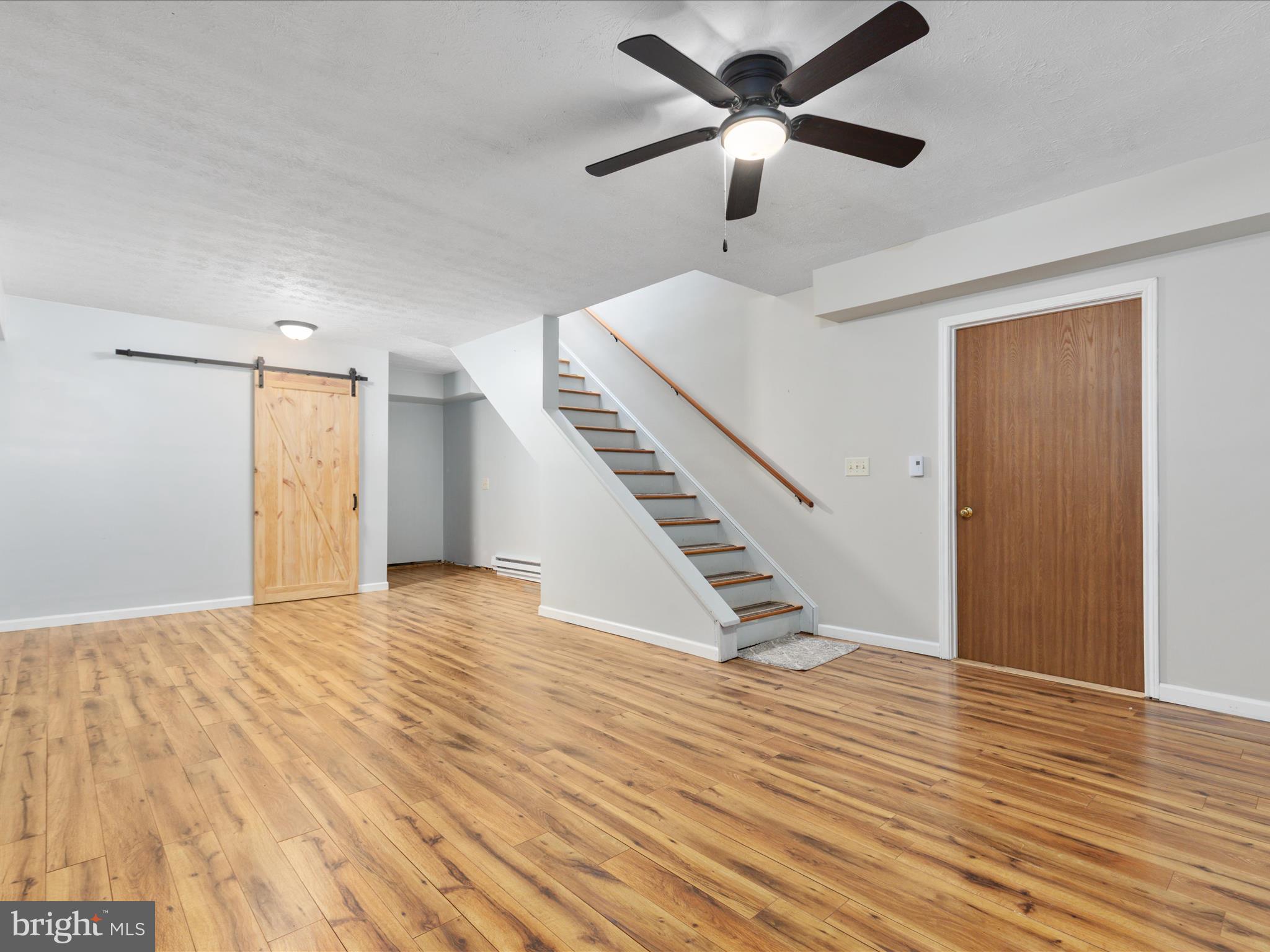 214 Walnut Drive Clear Brook, VA 22624 - Photo 36 of 75 a view of an empty room with wooden floor and a ceiling fan