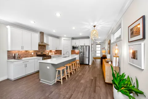 a kitchen with counter top space a sink appliances and cabinets
