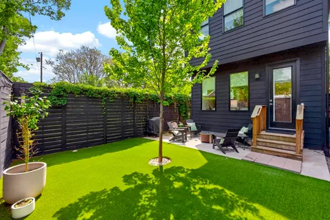 a view of a backyard with sitting area and furniture