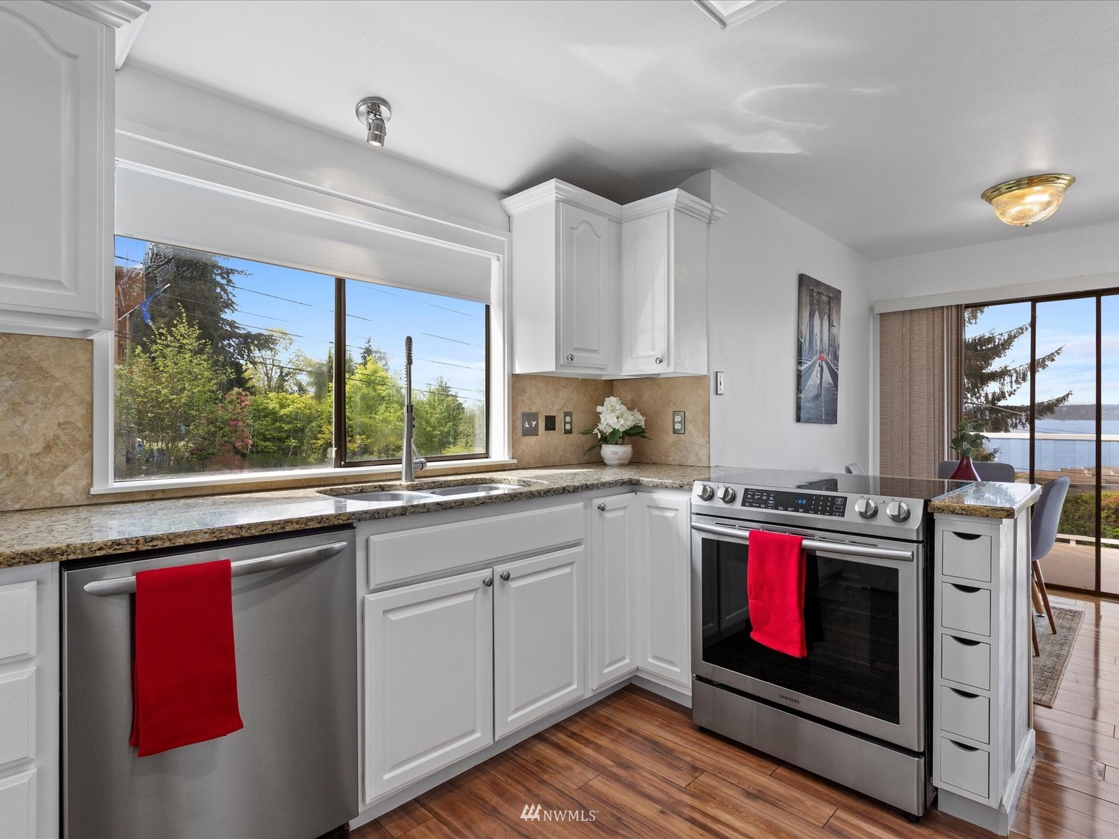 18156 Riviera Place Southwest Normandy Park, WA 98166 - Photo 11 of 40 a kitchen with stainless steel appliances a stove sink and window