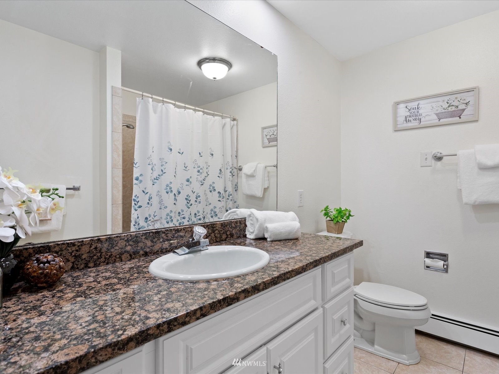 18156 Riviera Place Southwest Normandy Park, WA 98166 - Photo 15 of 40 a bathroom with a granite countertop sink and a mirror