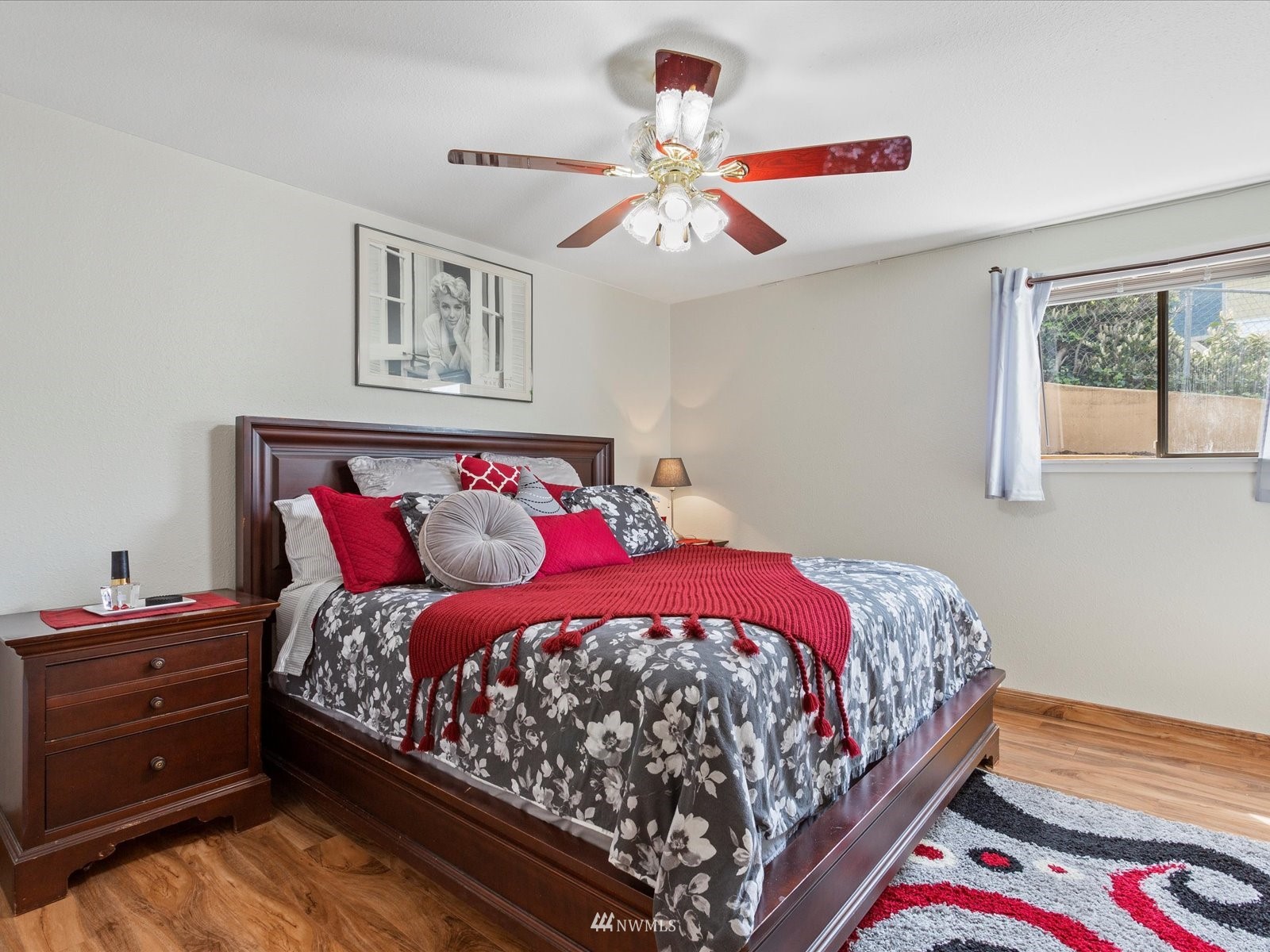 18156 Riviera Place Southwest Normandy Park, WA 98166 - Photo 19 of 40 a bedroom with a bed and a chandelier