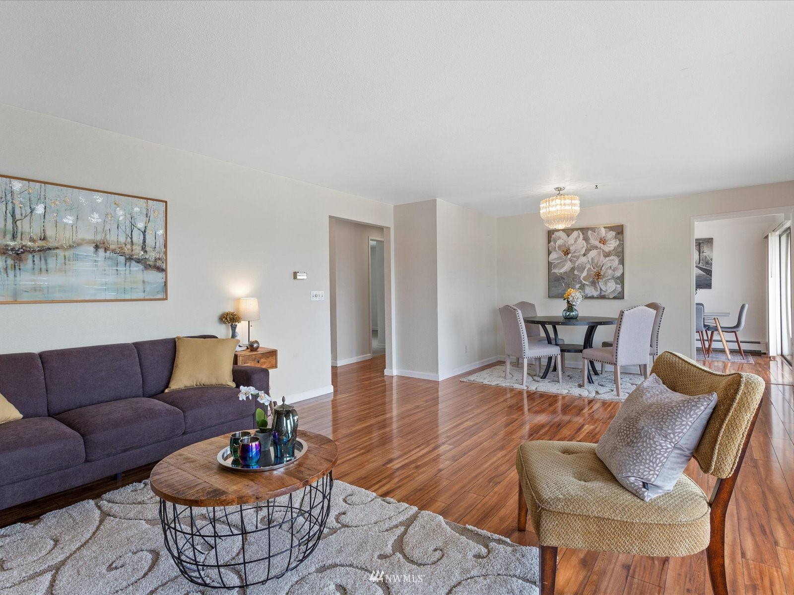 18156 Riviera Place Southwest Normandy Park, WA 98166 - Photo 6 of 40 a living room with furniture couches and a dining table with wooden floor