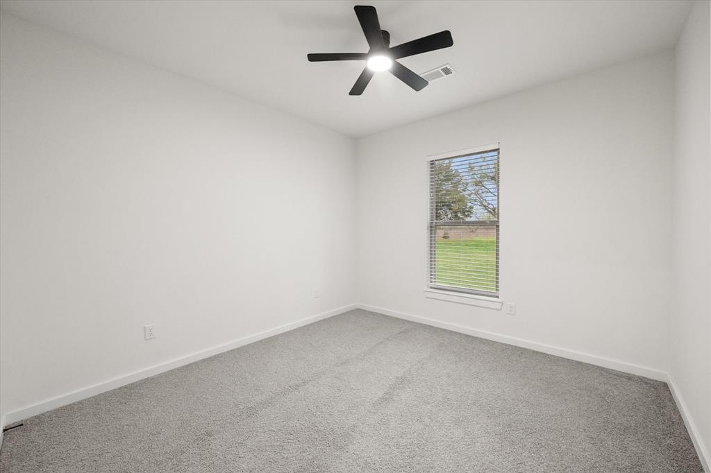 6771 Northwest County Road 1146 Barry, TX 75102 - Photo 20 of 34 an empty room with a window and a fan