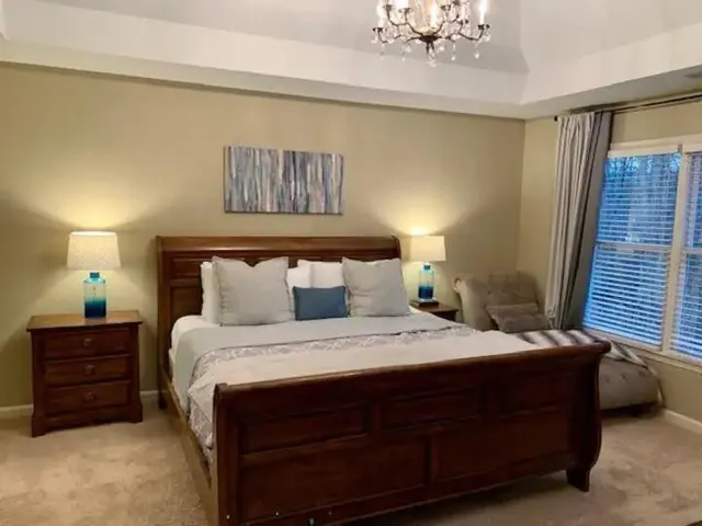 a bedroom with a bed and a chandelier