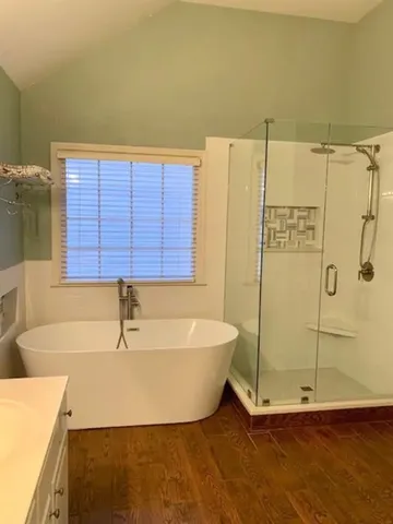 a bathroom with a tub and a shower