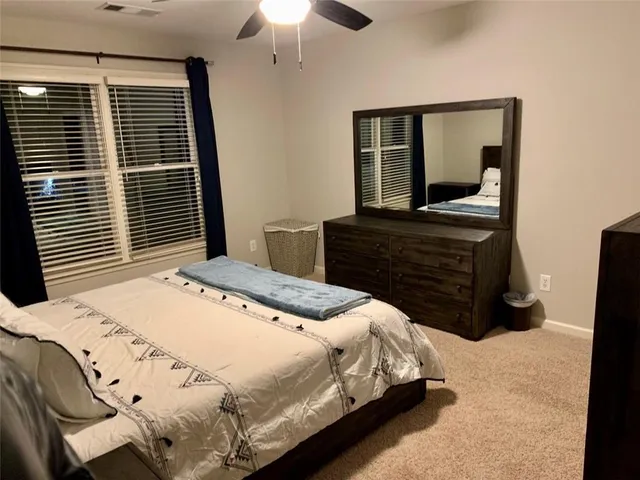 a bedroom with a bed and a dresser