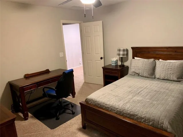 a bedroom with a bed and a dresser