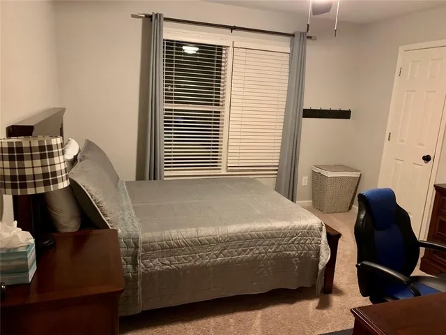 a bedroom with a bed and window
