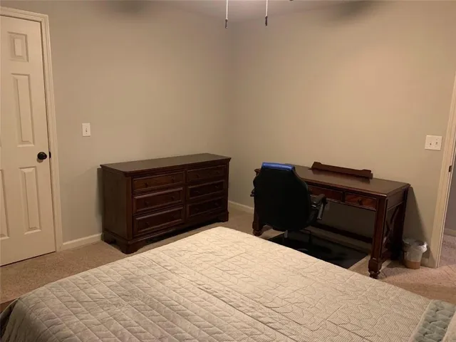 a bedroom with a bed dresser and a chair