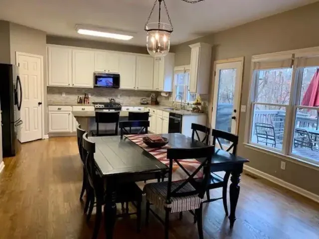 a view of a dining room with furniture window and wooden floor