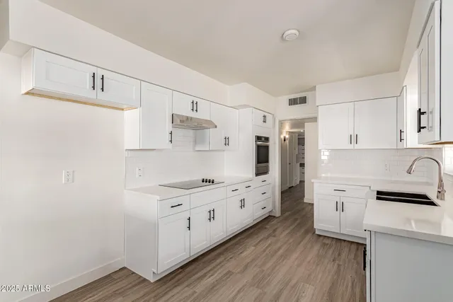 a kitchen with white cabinets and white appliances