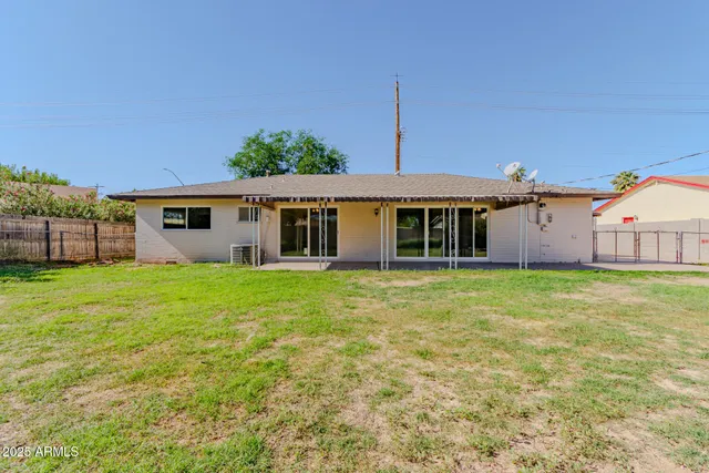 a view of a house with a backyard