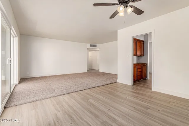 an empty room with wooden floor and closet