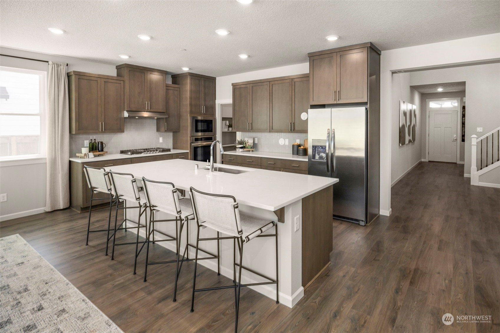 2814 South 9th Avenue Ridgefield, WA 98642 - Photo 2 of 37 a kitchen with stainless steel appliances a refrigerator a stove a sink dishwasher and a oven with wooden floor