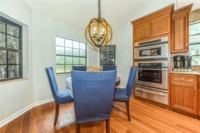 a view of a dining room with furniture window and wooden floor