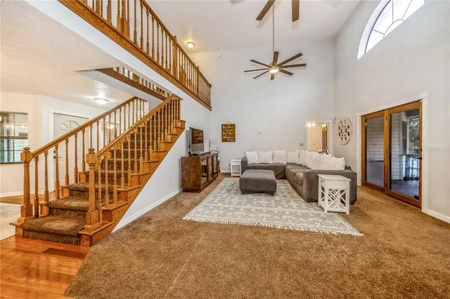 a living room with furniture or stairs and a wooden floor