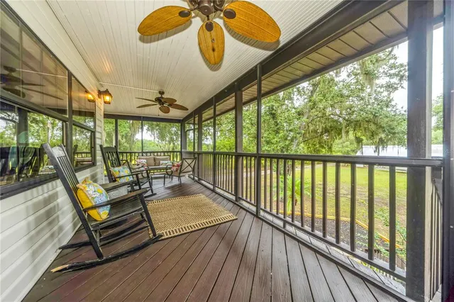 a view of a patio with a table chairs and wooden floor